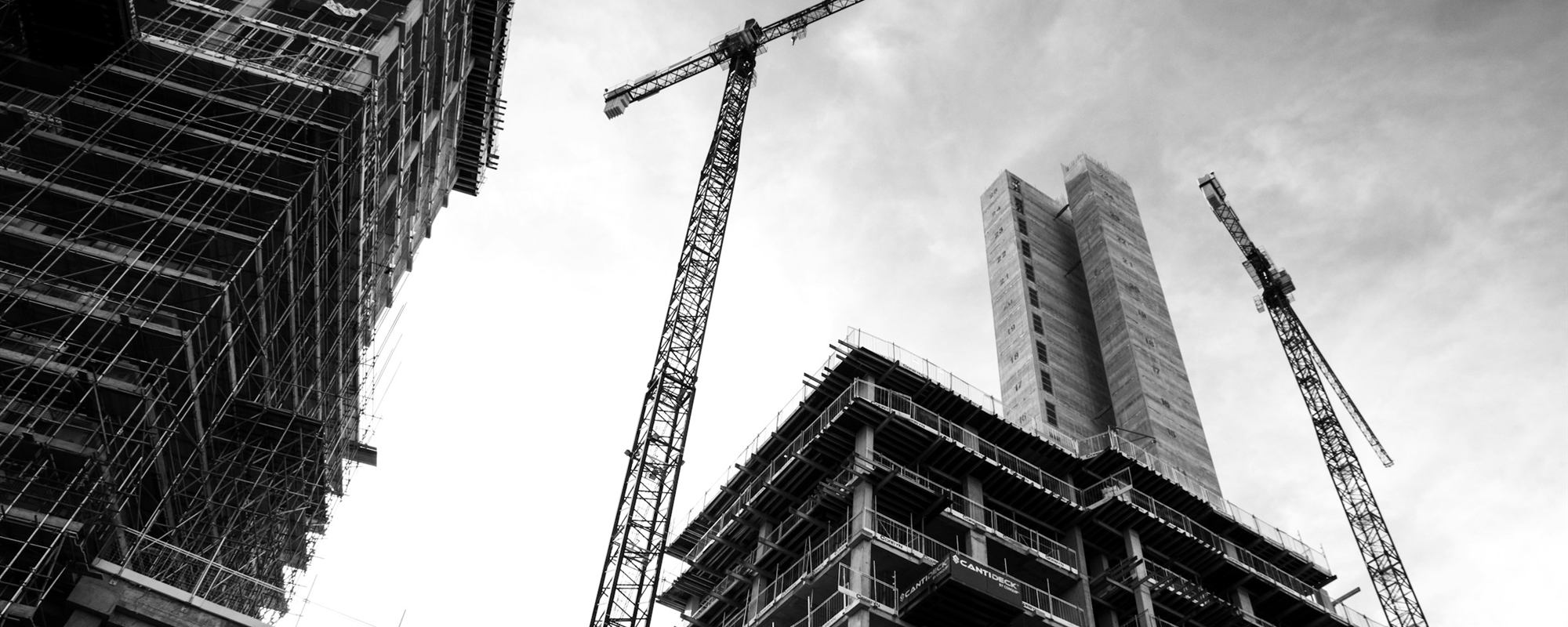 Tower cranes above new apartment buildings under construction