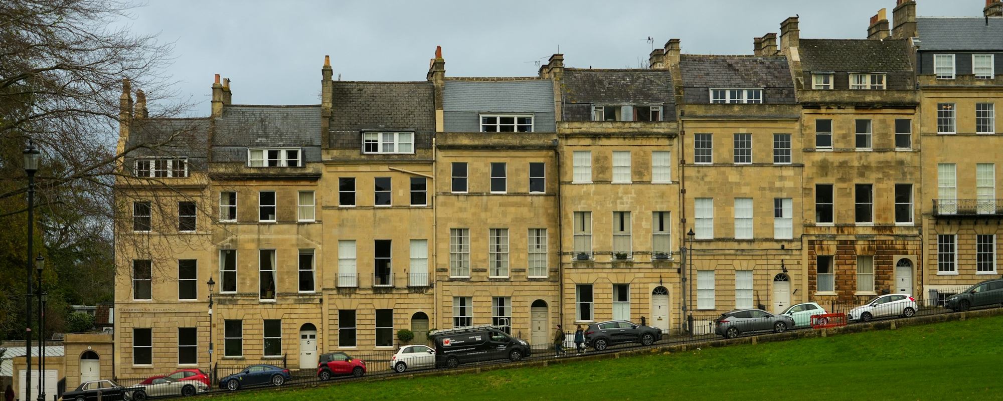 A terrace of Georgian stone townhouses above a lawn
