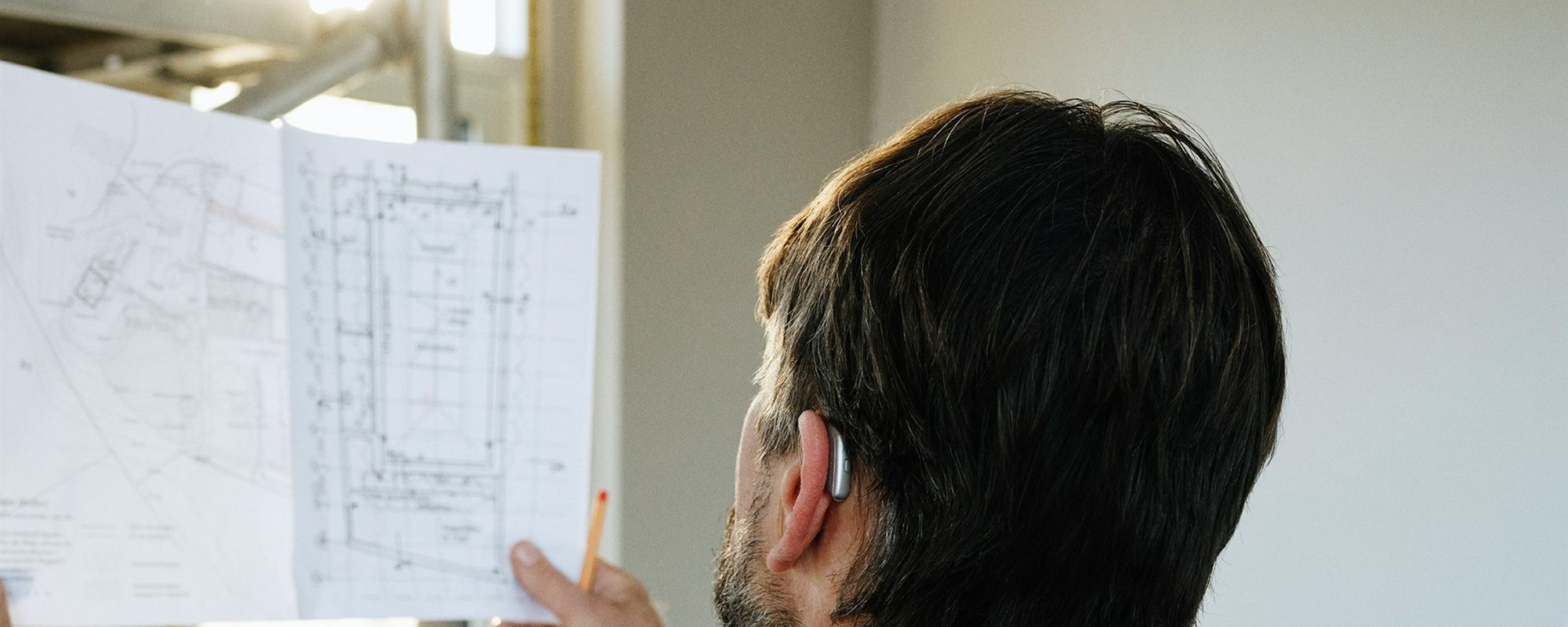 A member of the team reviewing building plans