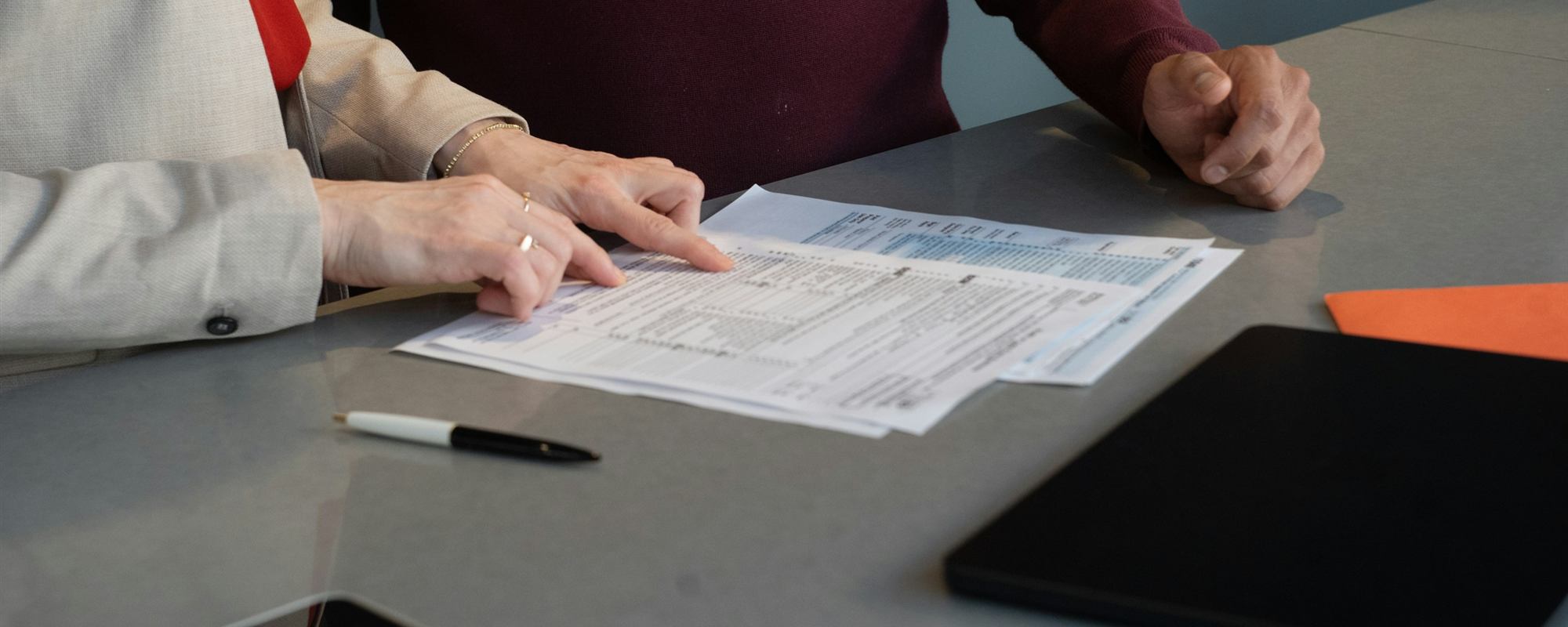 Two people reviewing documents at a table